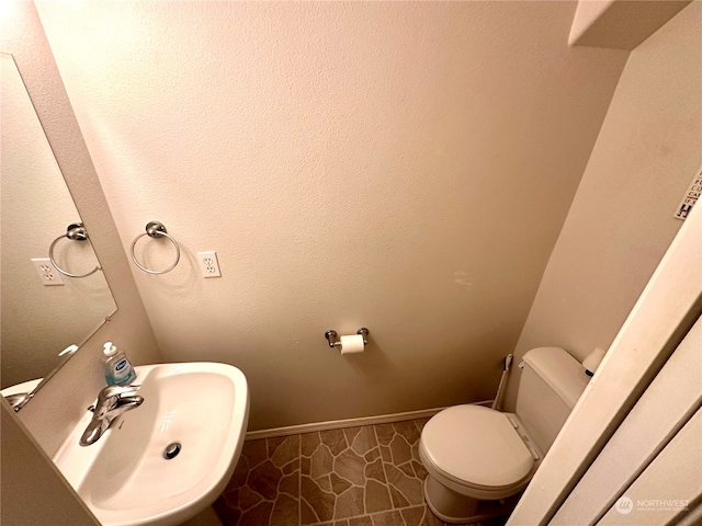 bathroom with sink, tile patterned flooring, and toilet