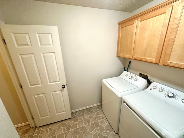 laundry room with cabinets and washer and dryer