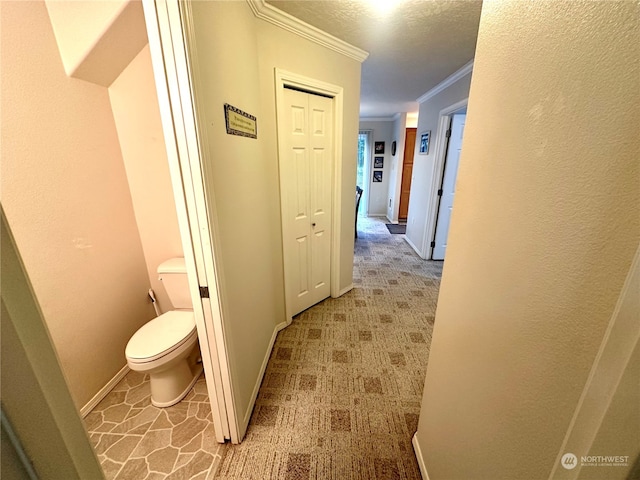 corridor with light colored carpet and ornamental molding