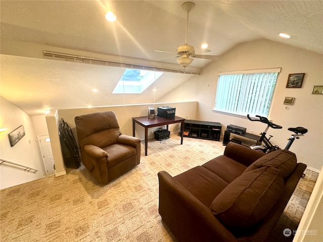 carpeted living room featuring ceiling fan and lofted ceiling with skylight