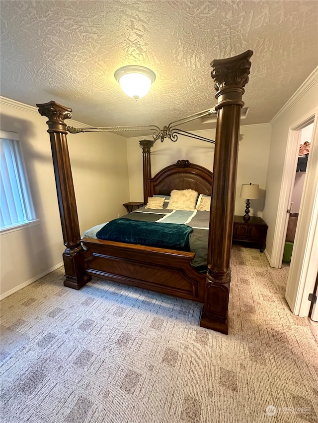 carpeted bedroom featuring ornamental molding and a textured ceiling