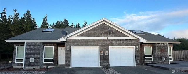 146 28th St NW, Long Beach, WA 98631 - view of front of home with an attached garage, driveway, and a shingled roof