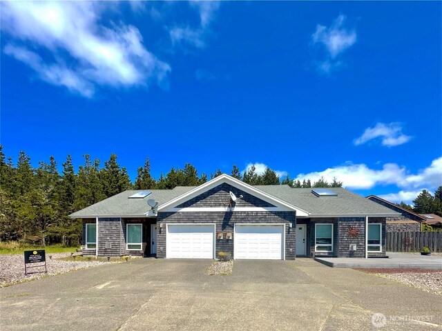 146 28th St NW, Long Beach, WA 98631 - view of front facade featuring an attached garage and driveway