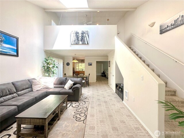 146 28th St NW, Long Beach, WA 98631 - living area featuring a towering ceiling, stairs, and light colored carpet
