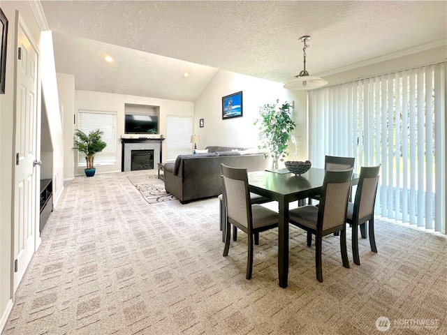 146 28th St NW, Long Beach, WA 98631 - dining space featuring light carpet, a fireplace, a textured ceiling, lofted ceiling, and recessed lighting