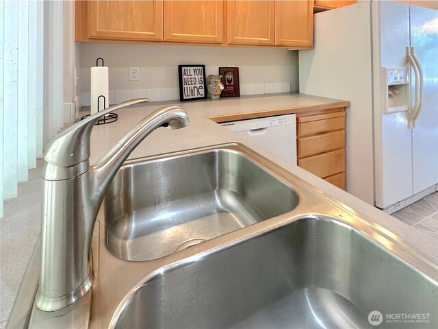 146 28th St NW, Long Beach, WA 98631 - kitchen featuring white refrigerator with ice dispenser, light countertops, and a sink