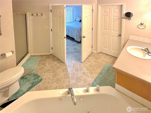 146 28th St NW, Long Beach, WA 98631 - ensuite bathroom featuring a whirlpool tub, toilet, vanity, a shower stall, and baseboards