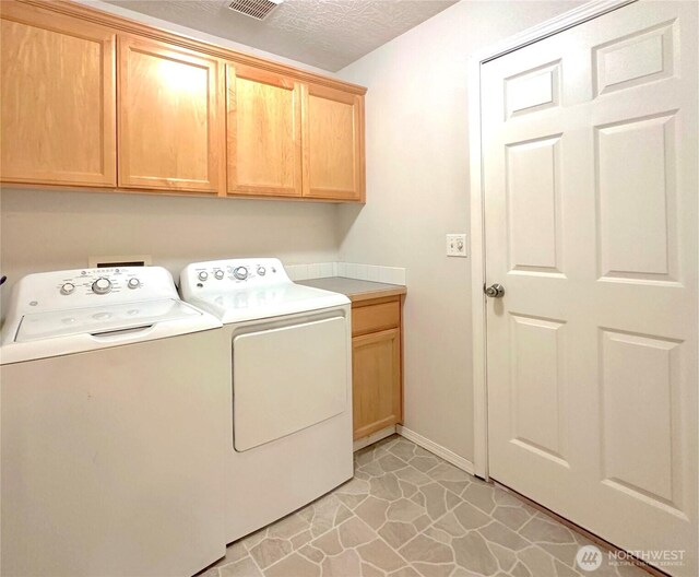 146 28th St NW, Long Beach, WA 98631 - laundry area featuring cabinet space, independent washer and dryer, and baseboards