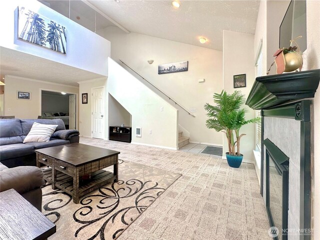 146 28th St NW, Long Beach, WA 98631 - living room featuring stairway, carpet, a textured ceiling, a fireplace, and ornamental molding
