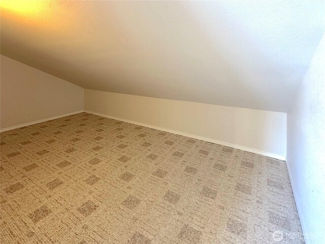 146 28th St NW, Long Beach, WA 98631 - bonus room featuring vaulted ceiling, carpet, and baseboards