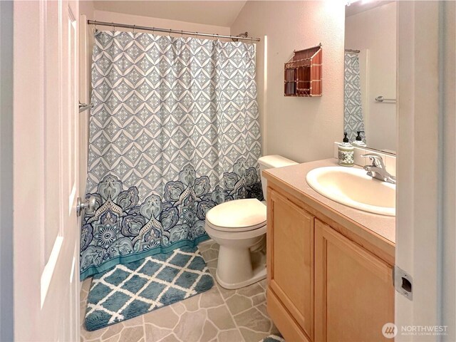 146 28th St NW, Long Beach, WA 98631 - bathroom with vanity, toilet, tile patterned flooring, and a shower with curtain