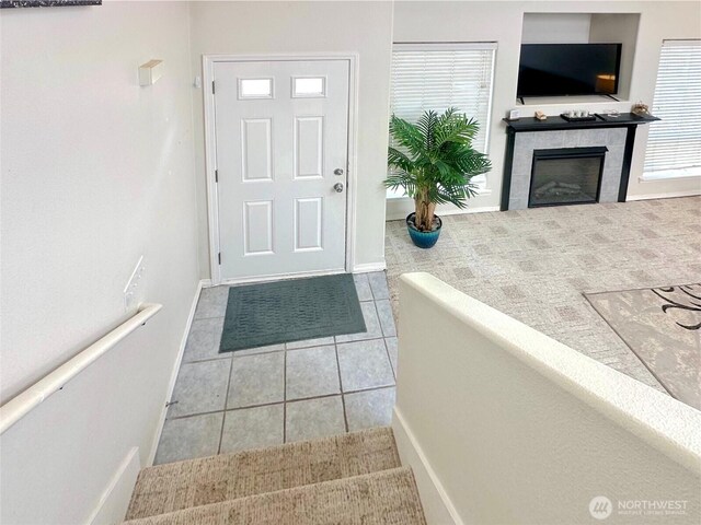 146 28th St NW, Long Beach, WA 98631 - foyer with a tile fireplace, tile patterned flooring, and baseboards