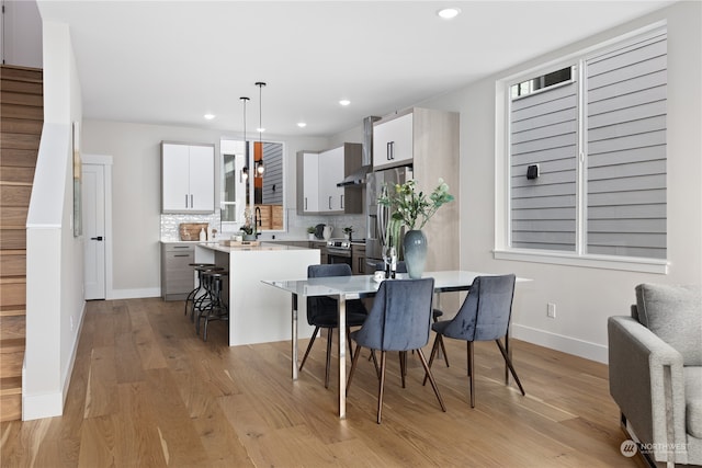 dining area featuring light wood-type flooring