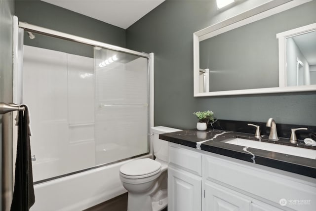 full bathroom with vanity, toilet, and bath / shower combo with glass door