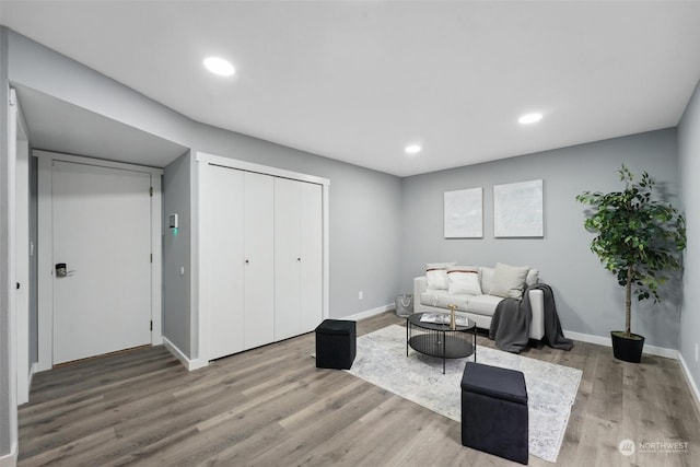 living area with hardwood / wood-style floors