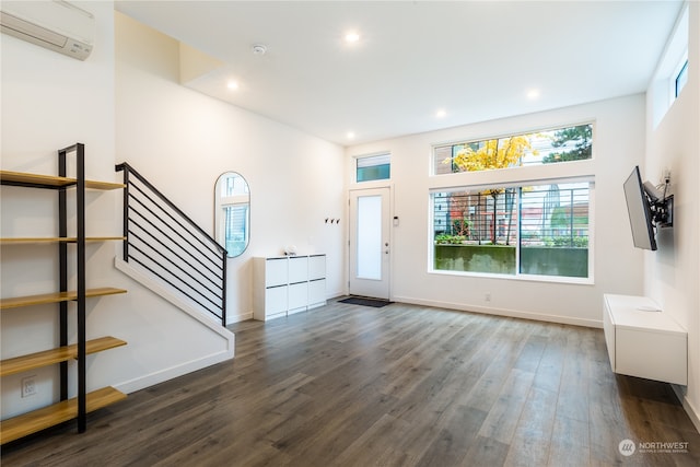 entrance foyer with dark wood-type flooring and a wall mounted air conditioner