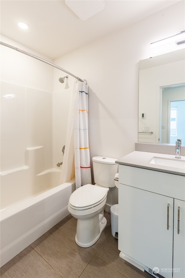 full bathroom with tile patterned floors, vanity, shower / bathtub combination with curtain, and toilet