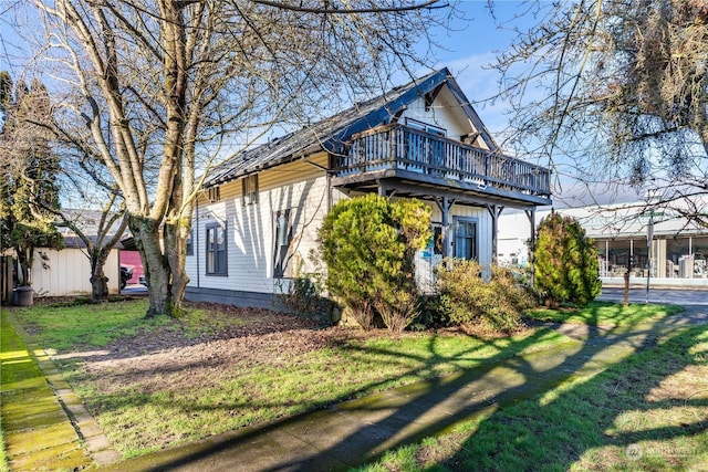 view of side of property with a lawn and a wooden deck