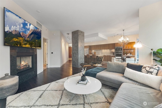 1920 4th Ave Unit 1802, Seattle, WA 98101 - living room featuring wood finished floors, a chandelier, and a glass covered fireplace