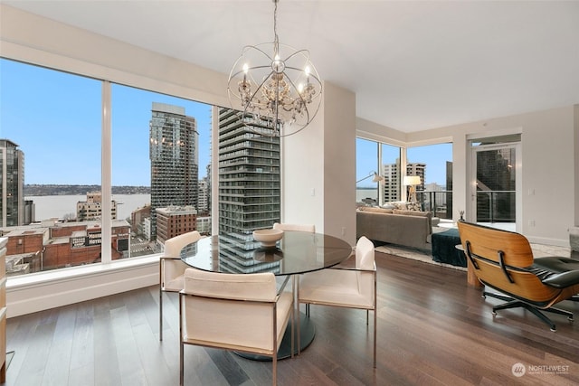 1920 4th Ave Unit 1802, Seattle, WA 98101 - dining room with wood finished floors, a chandelier, and a view of city