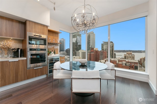 dining space featuring wine cooler, dark wood-type flooring, and an inviting chandelier