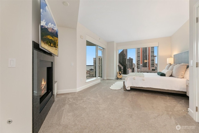 1920 4th Ave Unit 1802, Seattle, WA 98101 - carpeted bedroom with a glass covered fireplace, a view of city, and access to outside