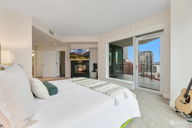 bedroom featuring access to outside and light colored carpet