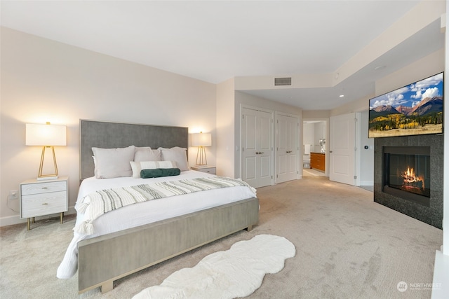 bedroom featuring light colored carpet