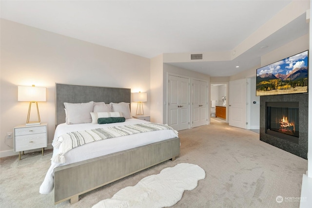 1920 4th Ave Unit 1802, Seattle, WA 98101 - bedroom with carpet flooring and a glass covered fireplace