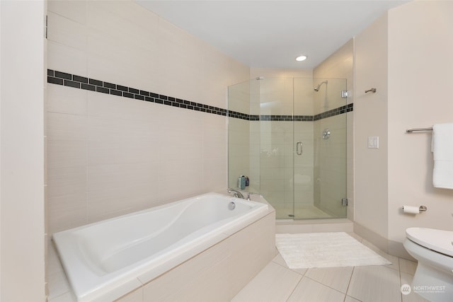 bathroom featuring tile patterned floors, separate shower and tub, and toilet