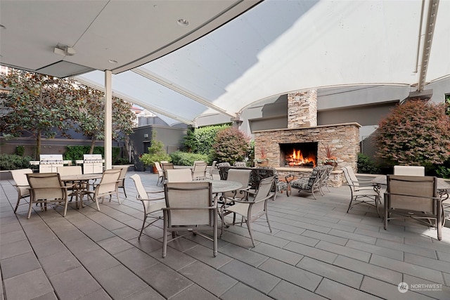 view of patio featuring an outdoor stone fireplace