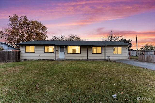 ranch-style home with a lawn