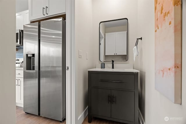 bathroom with wood-type flooring and vanity