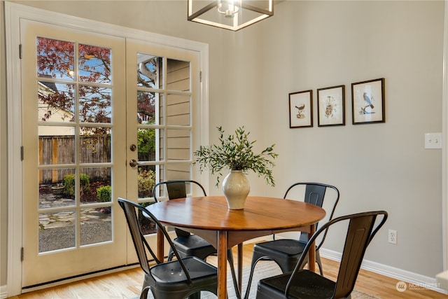 dining space with light hardwood / wood-style flooring and plenty of natural light