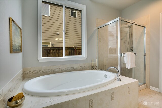 bathroom with tile patterned floors and shower with separate bathtub