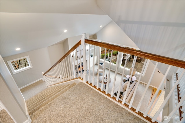 stairs featuring carpet flooring and lofted ceiling