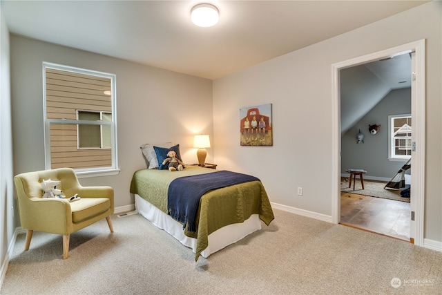 bedroom featuring carpet flooring and lofted ceiling