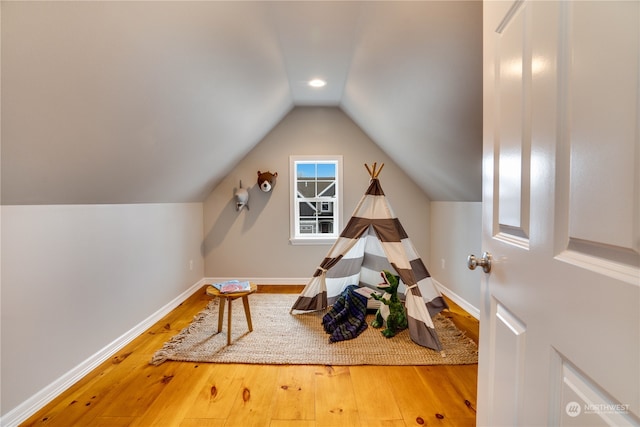 rec room with hardwood / wood-style floors and lofted ceiling