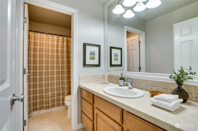 bathroom featuring tile patterned flooring, vanity, and toilet