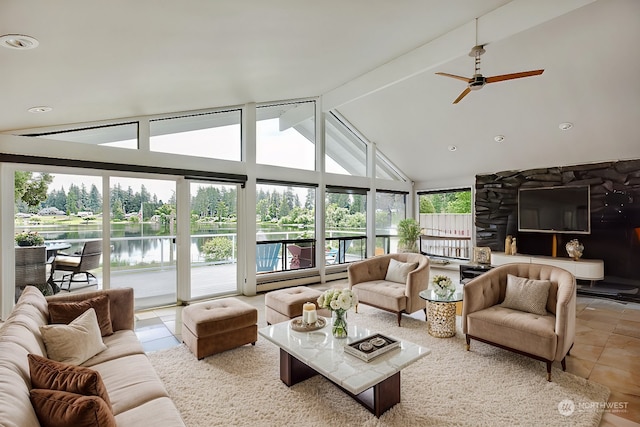 sunroom featuring ceiling fan, a water view, and lofted ceiling with beams