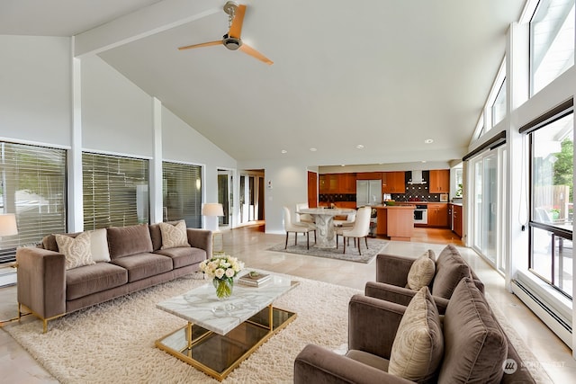 tiled living room with baseboard heating, ceiling fan, high vaulted ceiling, and a healthy amount of sunlight