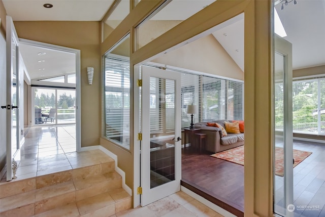 sunroom featuring french doors and vaulted ceiling