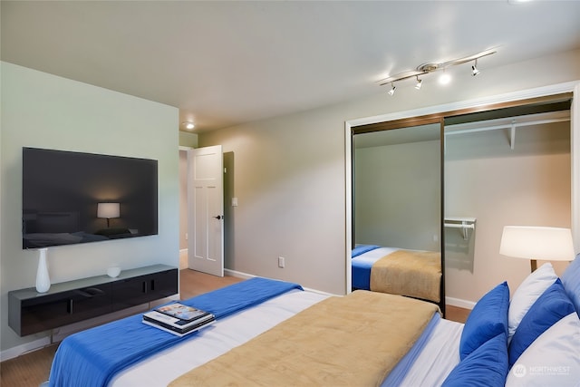 bedroom featuring hardwood / wood-style floors and a closet