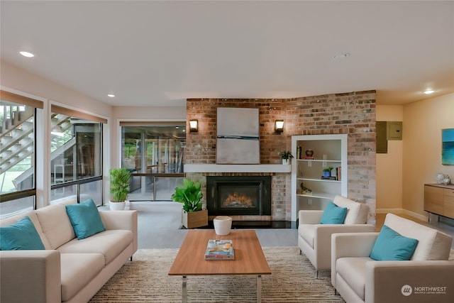 living room with a brick fireplace and light wood-type flooring