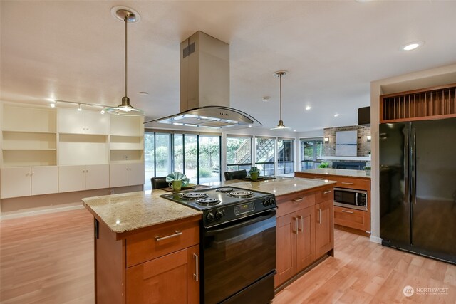 kitchen with black appliances, decorative light fixtures, light hardwood / wood-style floors, and island exhaust hood