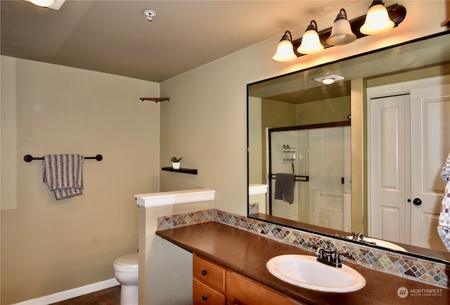 bathroom with vanity, toilet, and an enclosed shower