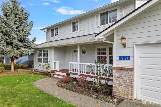 view of front of property with covered porch and a front yard