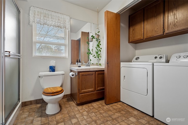 washroom with washer and clothes dryer and sink