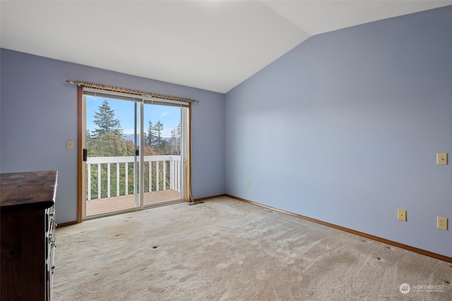 unfurnished living room with light carpet and vaulted ceiling