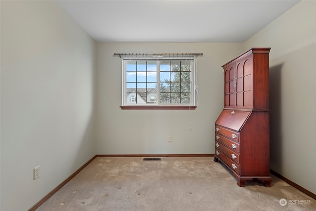 empty room featuring light carpet